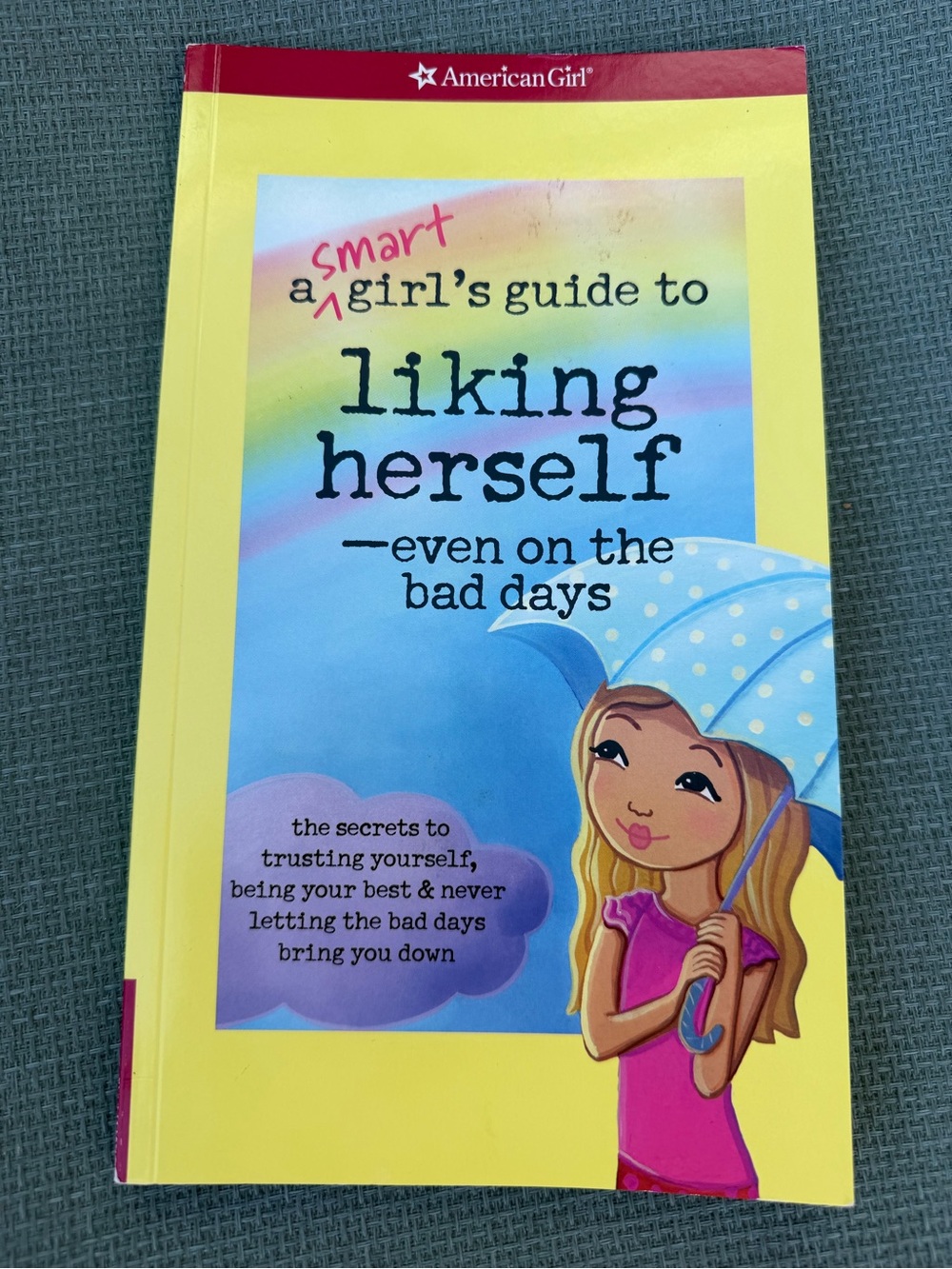 American Girl yellow paperback guidebook with rainbow accent
